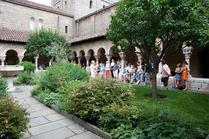 Visitors enjoy a guided tour of the gardens at The Met Cloisters